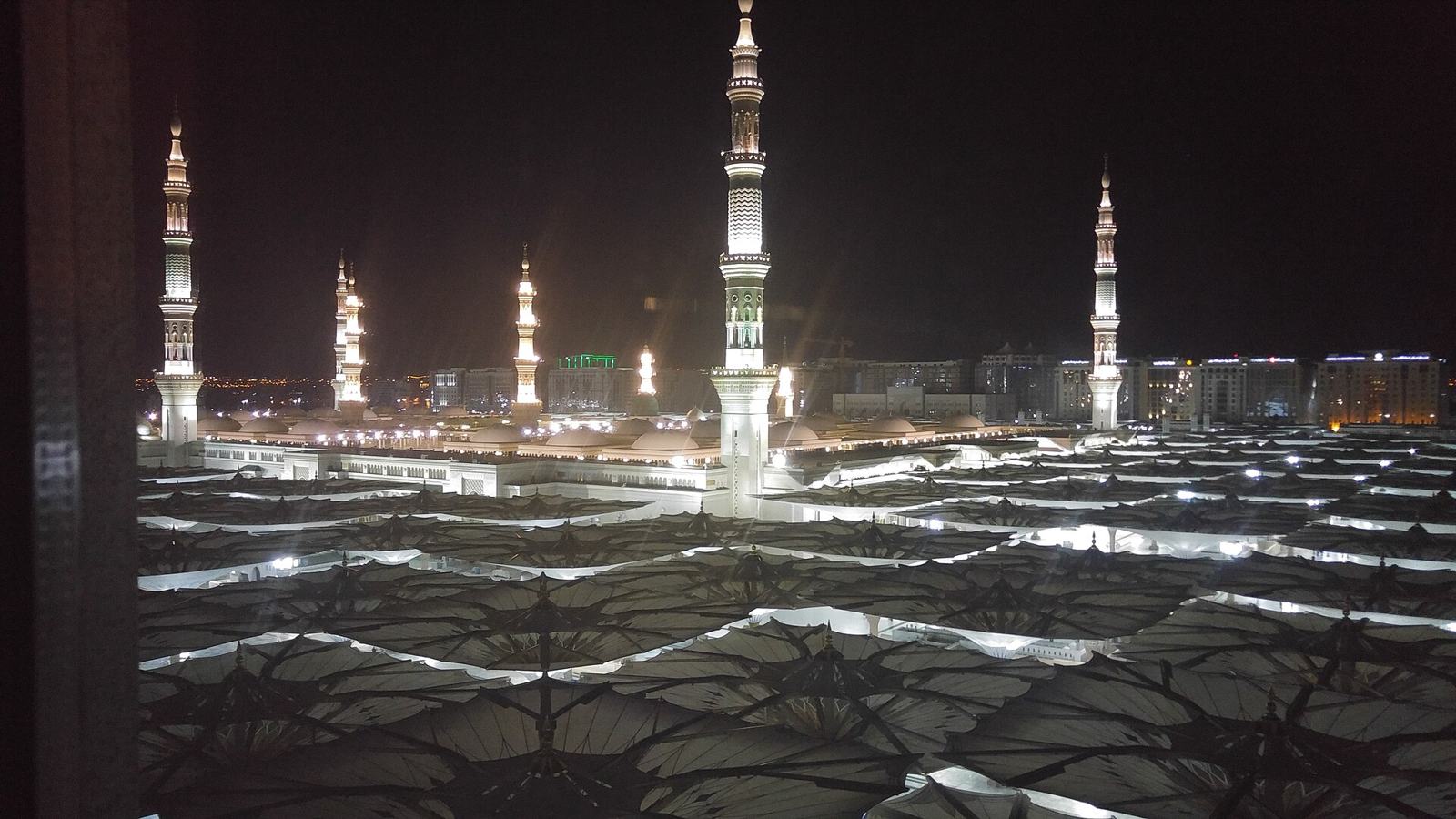 The piazza at night, umbrellas folded and minarets lit